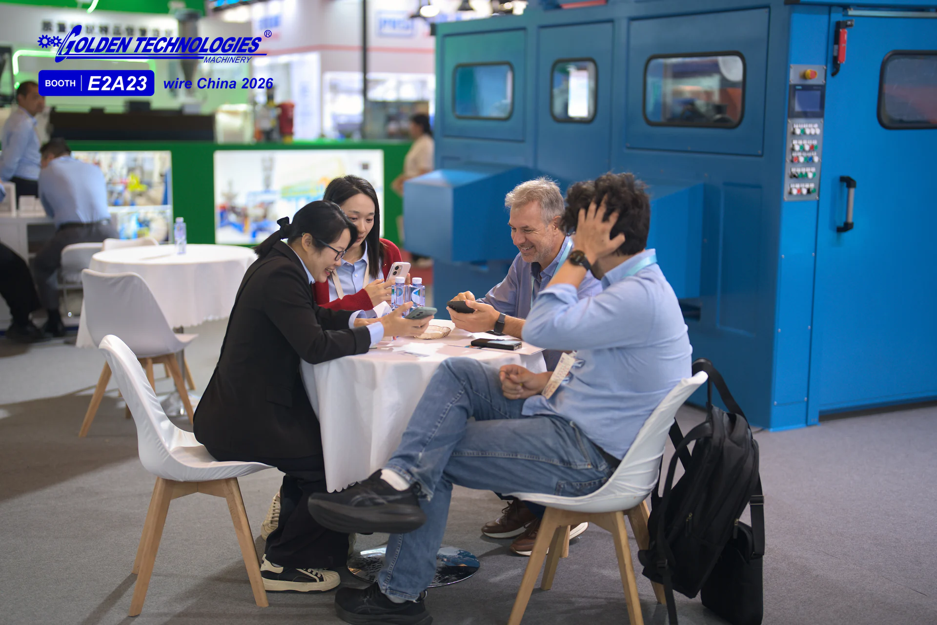 Visitors and Golden Technologies team meeting beside cable machinery at wire China 2026